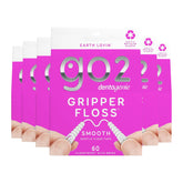 Packaging of go2 Gripper Floss with a hand holding floss on a white background
